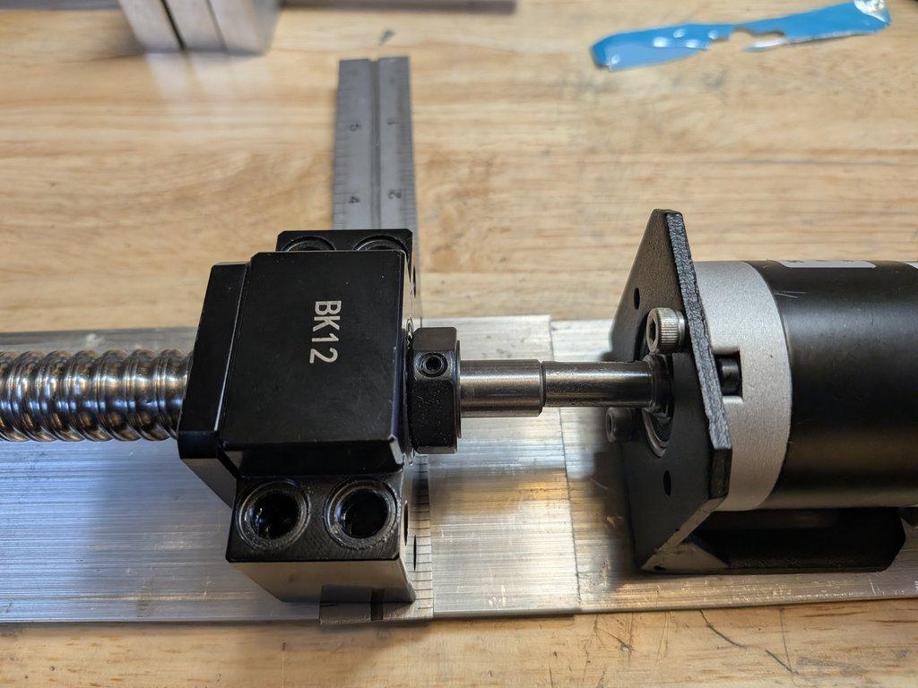 Boom motor drive mount and spacer