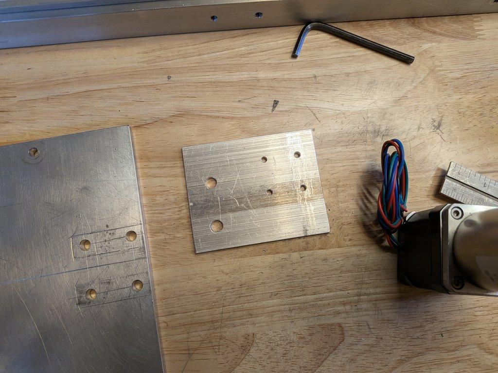 Swing axis motor mount plate