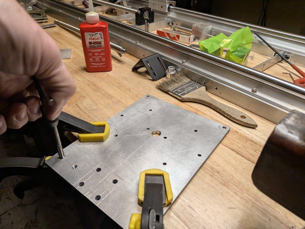 Swing axis motor mount plate