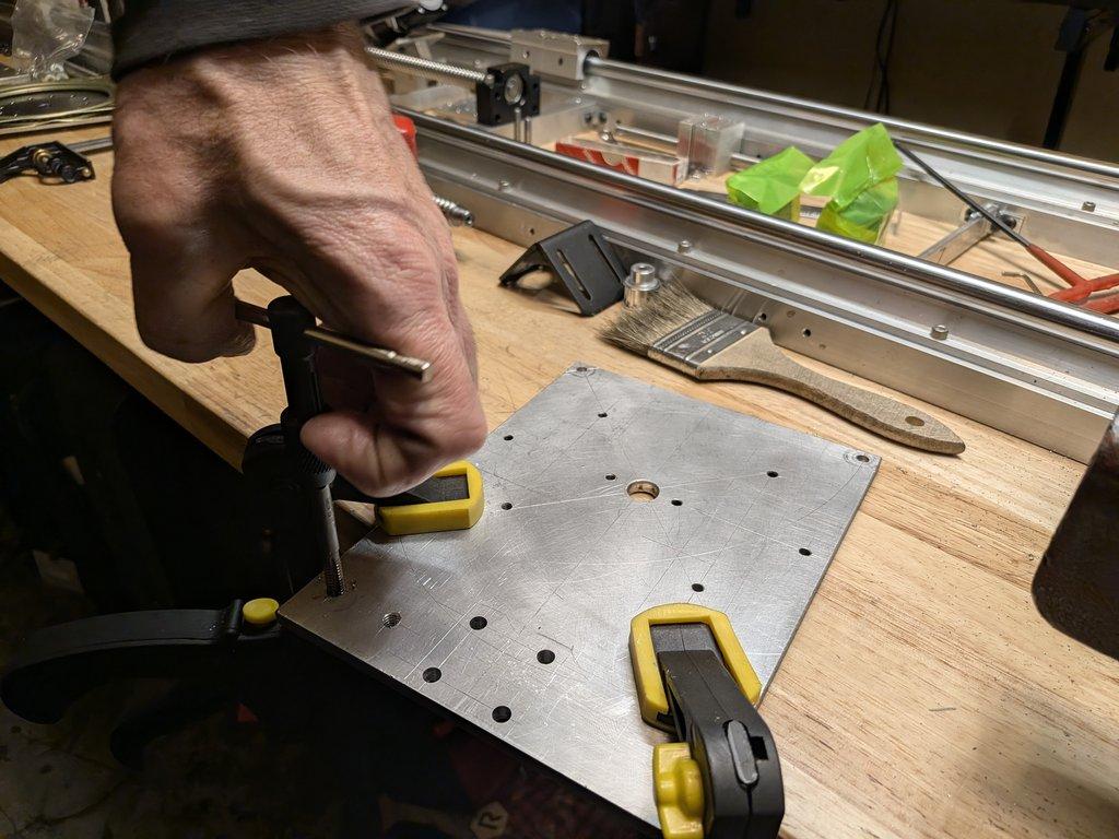 Swing axis motor mount plate