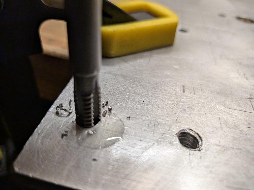 Swing axis motor mount plate