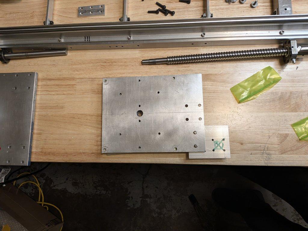 Swing axis motor mount plate